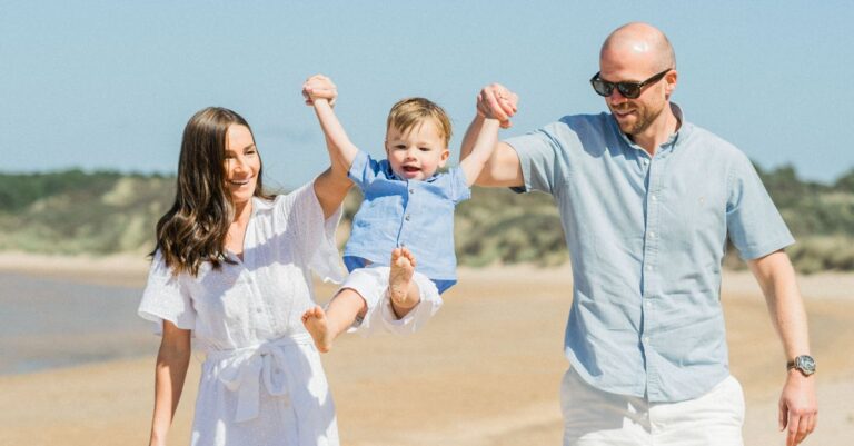 A family playing together on a sunny beach, similar to a family day out at Pasco County's SunWest Park