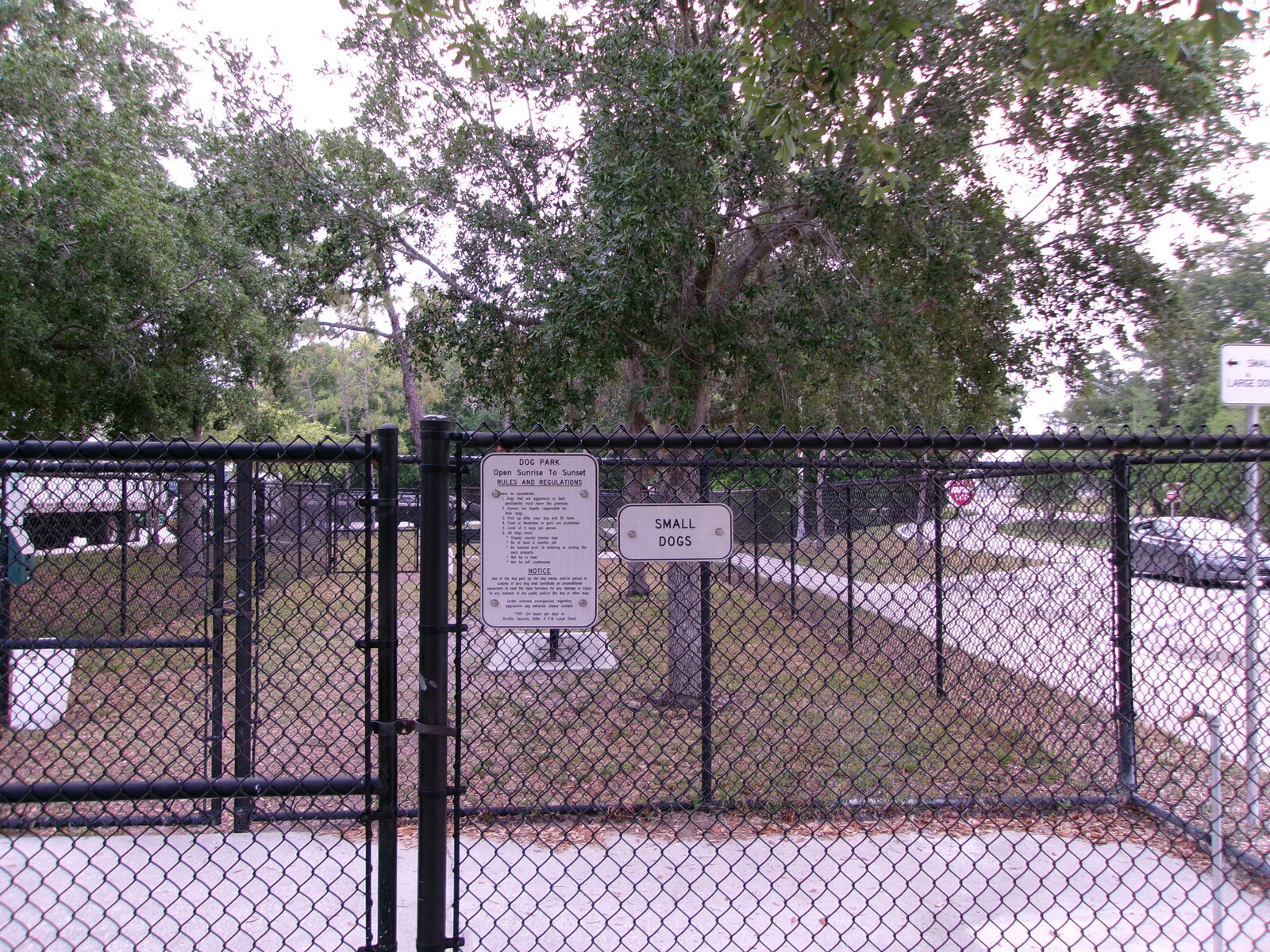 Fenced dog park gate and posted rules sign at the I-75 southbound Pasco County rest area