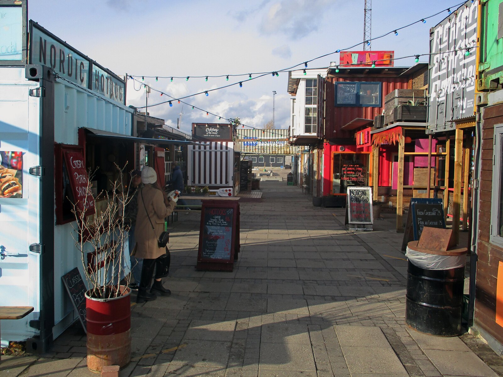 An outdoor shipping-container-style food hall market, similar in style to KRATE at the Grove