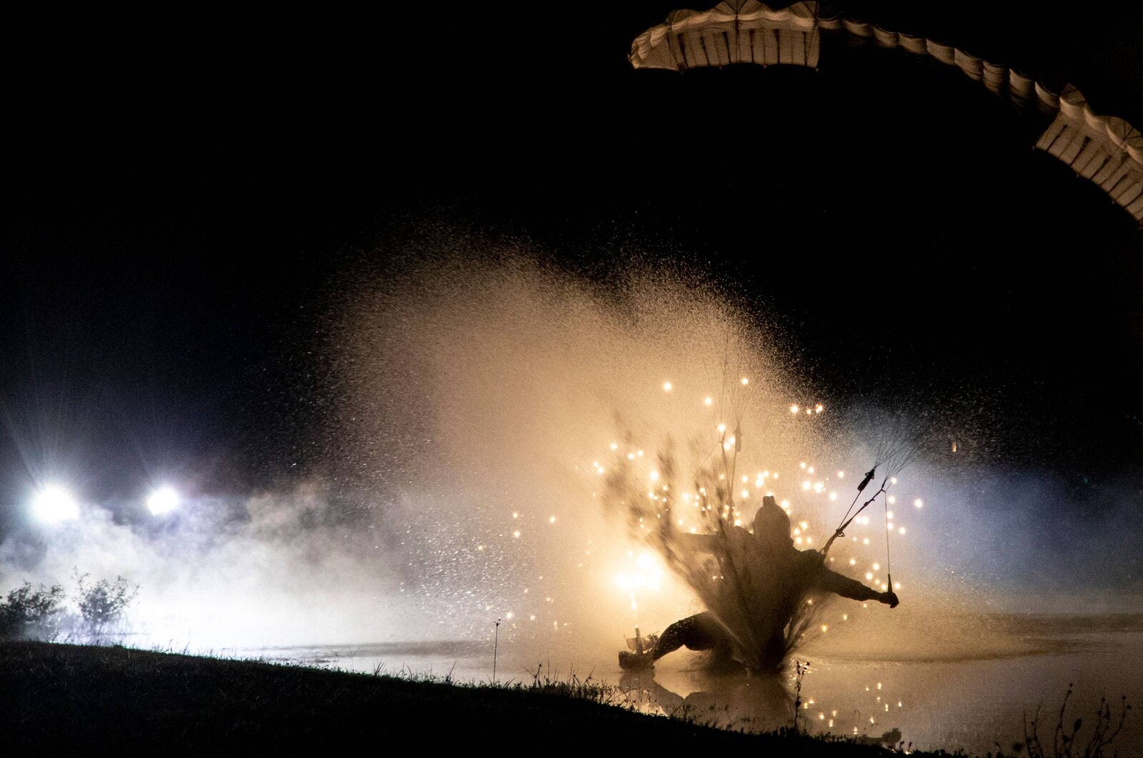 Skydiver landing in a lit swoop pond at night at Skydive City in Zephyrhills
